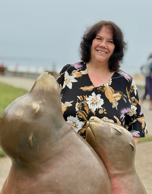 Cami Corvin at the Capitola seafront with the sea lion sculptures
